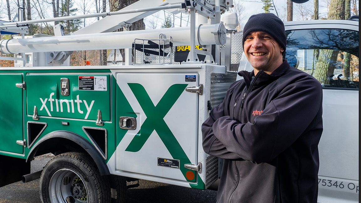 Technician standing near Xfinity truck